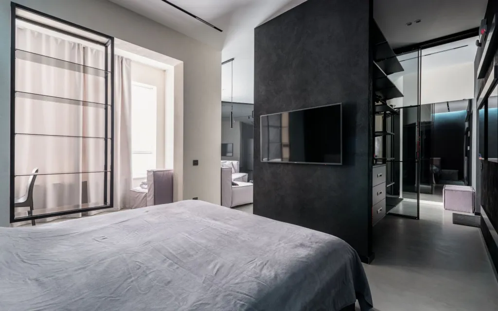 A light bedroom framed by curtains
