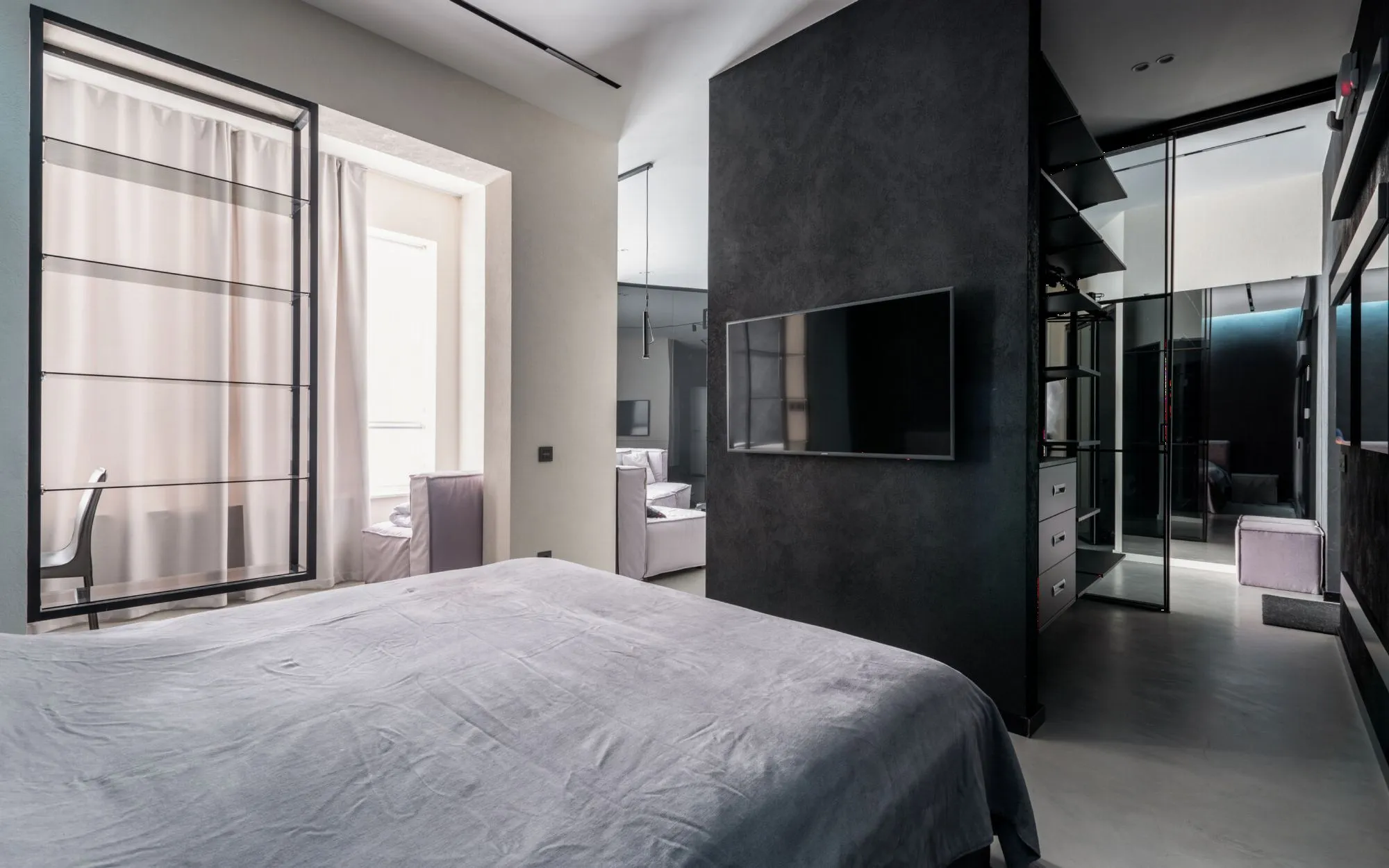 A light bedroom framed by curtains